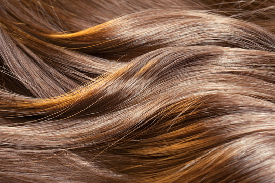 Beautiful healthy shiny hair texture with highlighted streaks