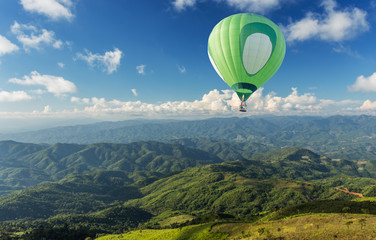 Hot air balloon over tea plantation with blue sky background