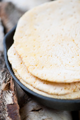 Close-up of tortilla bread in a frying pan, vertical shot