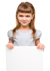 Fototapeta premium Little girl is holding blank banner