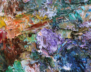Abstract background mixing oil paints on a palette.