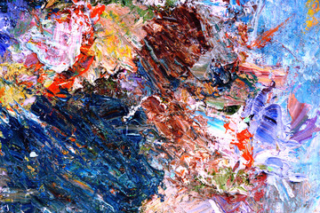 Abstract background mixing oil paints on a palette.
