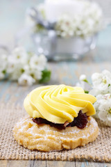 Fairy yellow cake. Beautiful blooming apple twig in the back