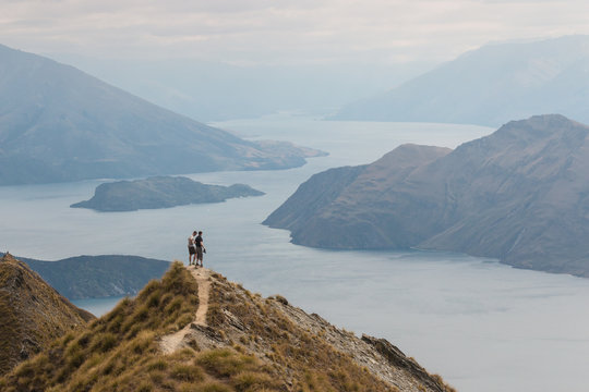 tourists admiring lake Wanaka, New Zealand