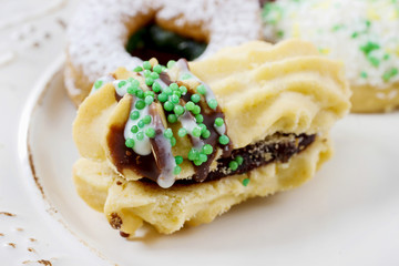 Eclairs with jam decorated with green sprinkles