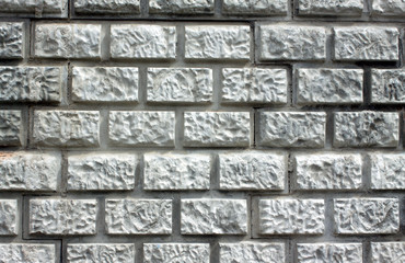 Wall with decorative coating styled gray brick closeup