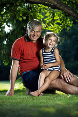 Grandfather and granddaughter outdoors