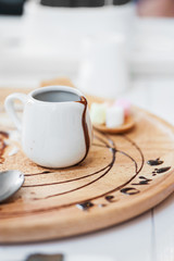 chocolate in small jar on wood disk .