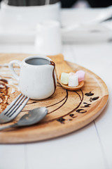 chocolate in small jar on wood disk .