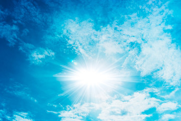 Blue sky with clouds and sun