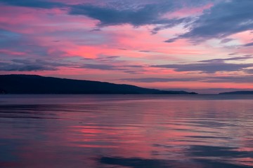 Fototapeta na wymiar Pink sunset on a cloudy evening