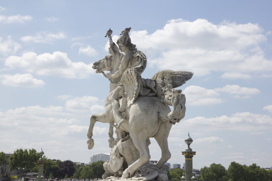 Ancient sculpture in Paris over the blue sky