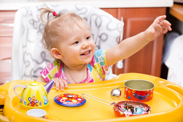 Portrait of child girl on kitchen.