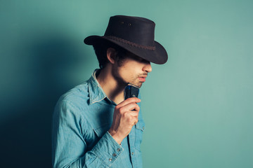 Cowboy shaving with electric shaver