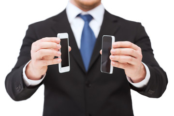 businessman showing smartphones with blank screens