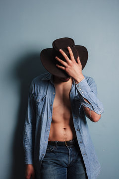 Sexy young cowboy with his shirt open