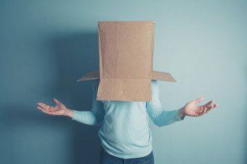 Confused man with cardboard box on his head