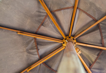 Under wooden umbrella
