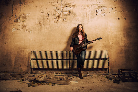lady in black jacket with guitar