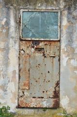 abandoned iron and glass door