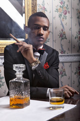Elegante gentleman with cigar and whisky