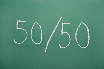 Fifty-fifty chance handwritten on chalkboard