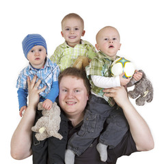 Father carrying his three children on shoulders