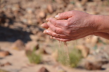 Hand and sand