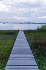 Fototapeta premium Pier at the coast with boats in the background, Georgian Bay, To