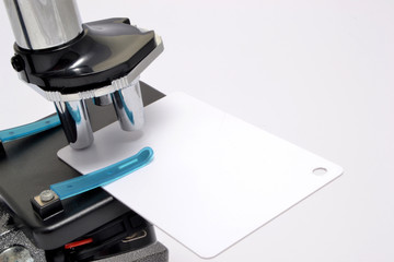 microscope analyzing a white card