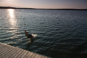 Man diving in a bay, Georgian Bay, Tobermory, Ontario, Canada