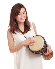 Asian woman playing a djembe