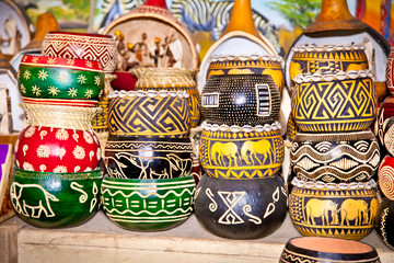 Obraz premium Colorfully painted wooden pots in market, Africa.