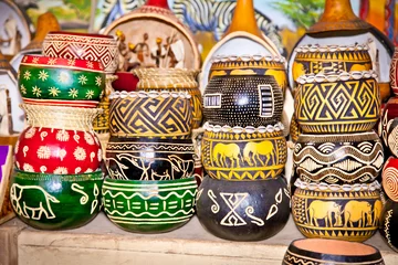 Poster Colorfully painted wooden pots in market,  Africa. © Aleksandar Todorovic