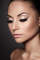 Closeup portrait of young beautiful woman with long eyelashes