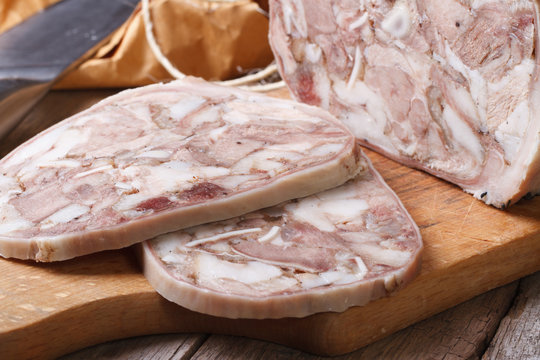 Headcheese chopped on kitchen board macro