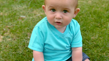 Cute baby sitting on the grass