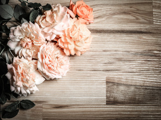 Vintage retro background with roses on wood.
