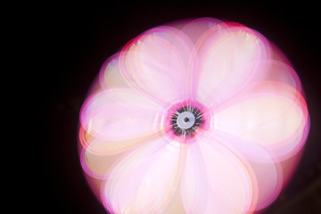 An abstract of a pink pinwheel in motion