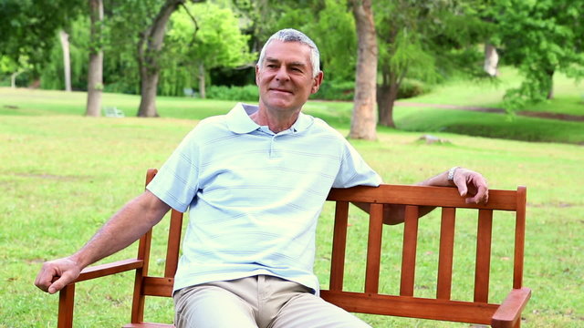 Retired man relaxing on a park bench