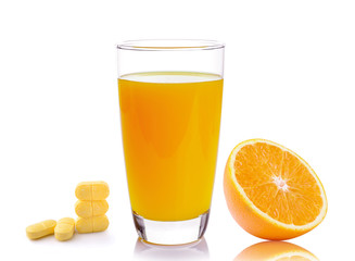 Full glass of orange juice and Vitamin C pills  isolated on whit