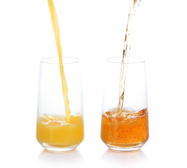 Juice pouring into glass isolated on white