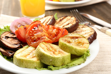 Delicious grilled vegetables on plate on table close-up