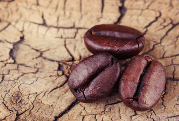 Coffee Beans on Old Wooden Background. Macro