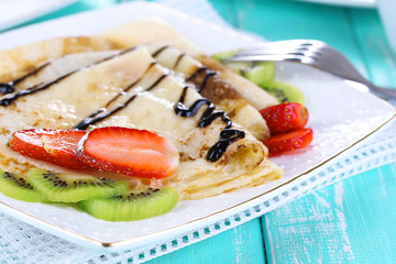 Delicious pancakes with strawberries and chocolate