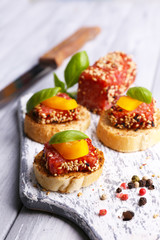 Composition of knife,  tasty sandwiches with salami sausage,