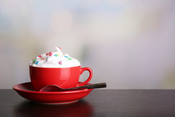 Cup of strong coffee with cream and candies