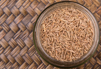Cumin seeds over a wicker background 