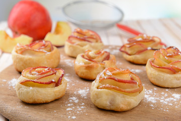 Tasty  puff pastry with apple shaped roses on table close-up