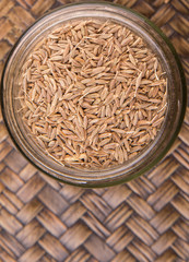 Cumin seeds over a wicker background 